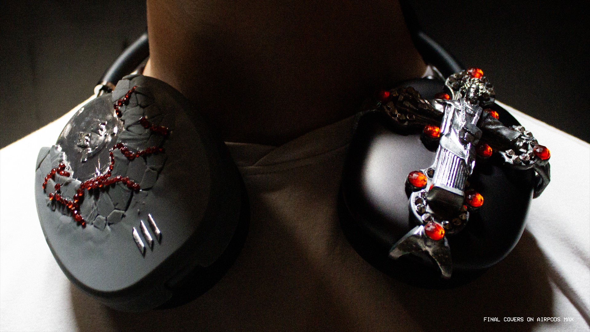 Headphones with a dragon design and a small figure holding a gun, both decorated with red and black elements.