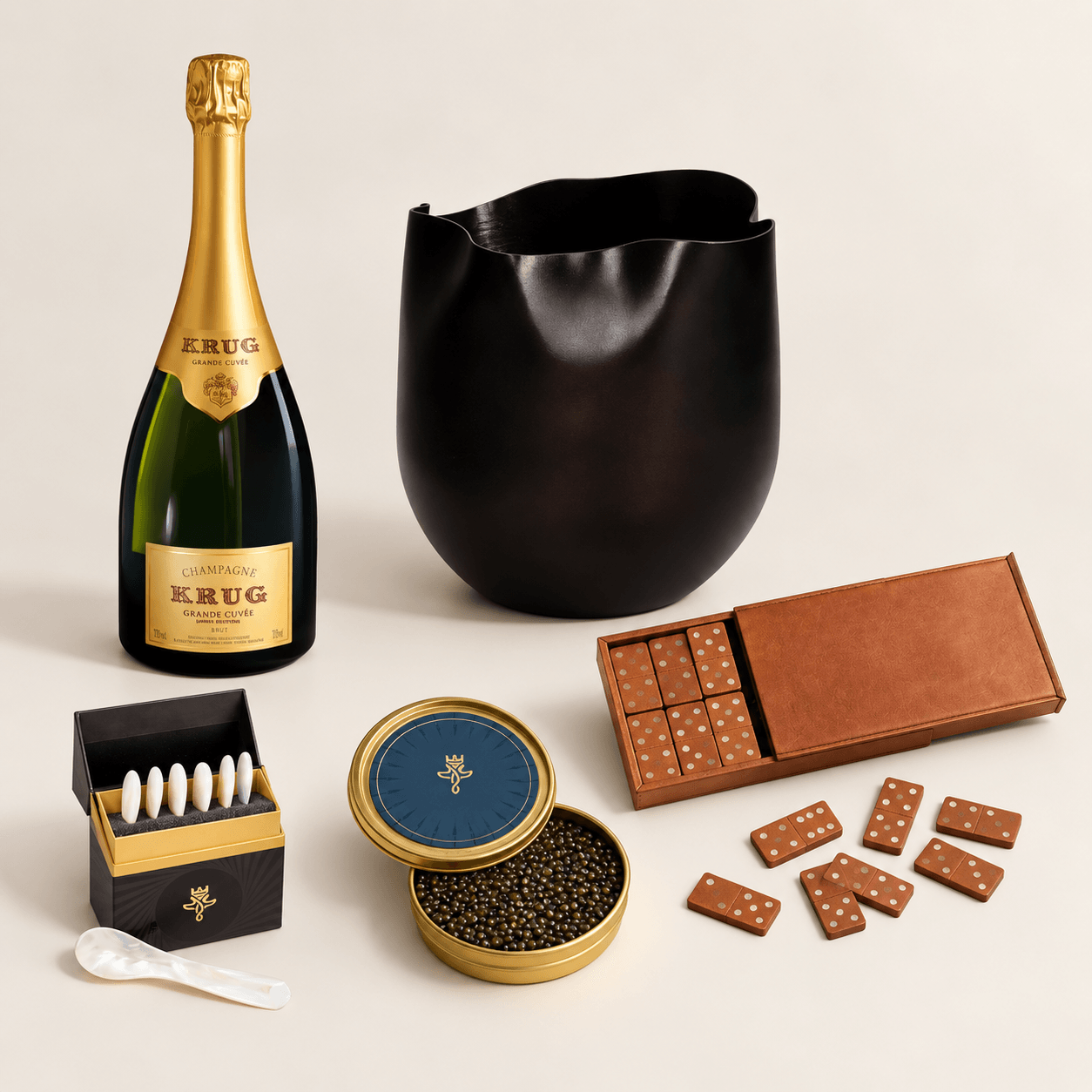 Champagne bottle, black bag, chocolate box, chocolates, and a container of caviar with a spoon on a white background.