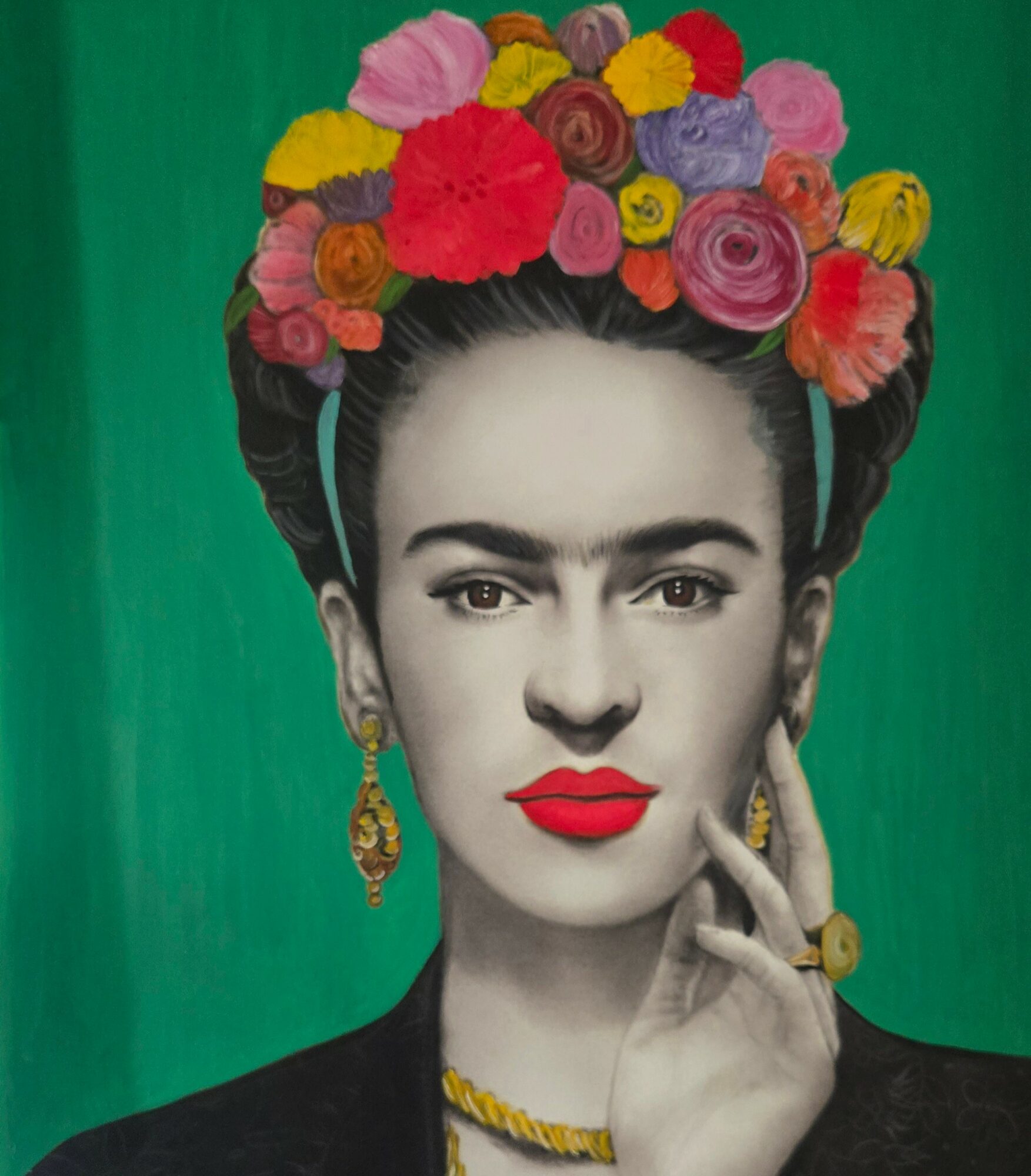 Portrait of a woman with a colorful floral headdress, red lipstick, gold jewelry, and a black outfit against a green background.