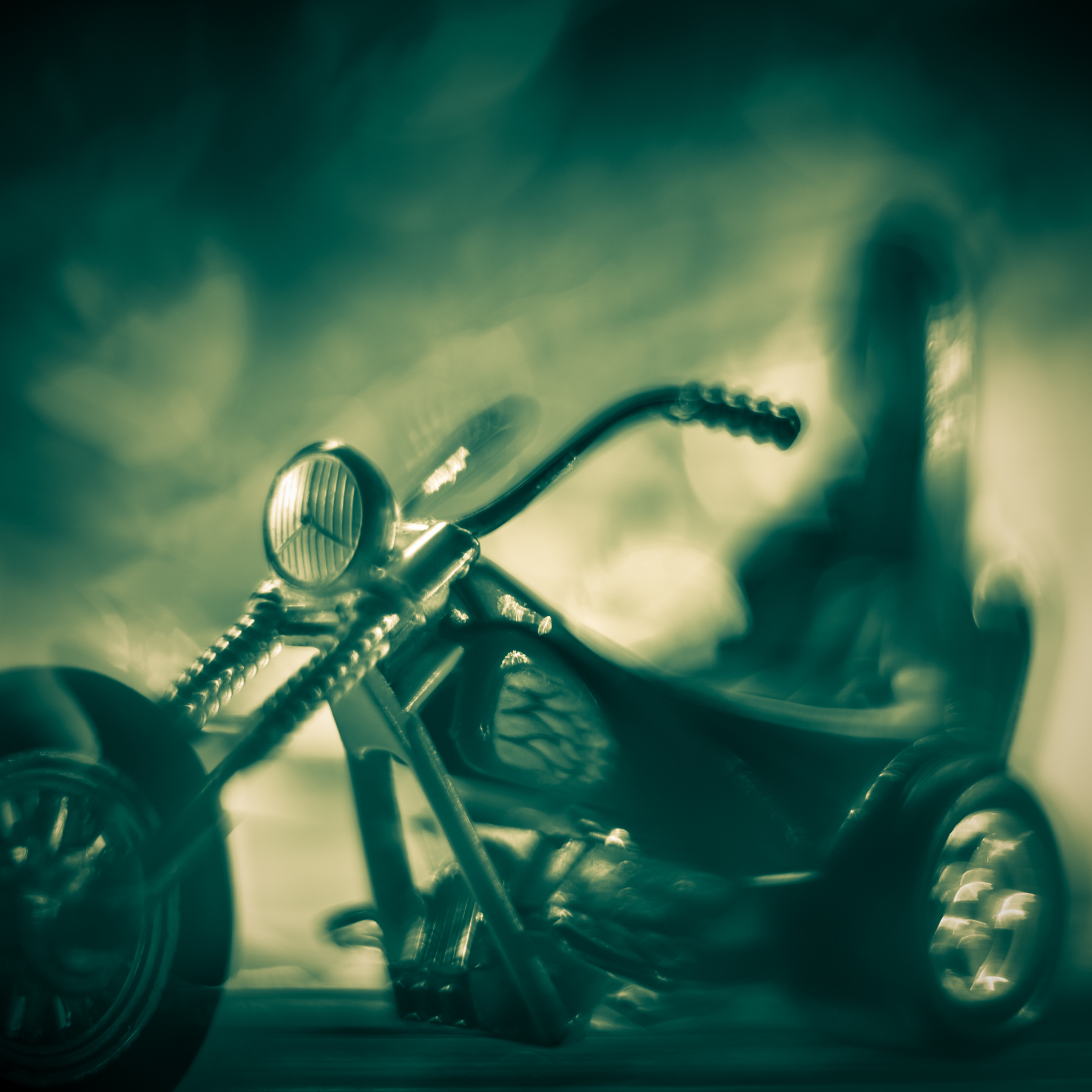 Motorcycle with a blurred, ghostly figure in the background, set against a cloudy sky.